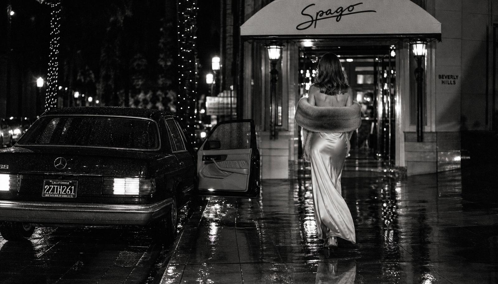 A woman in silk stepping from a black car outside a Beverly Hills restaurant at night